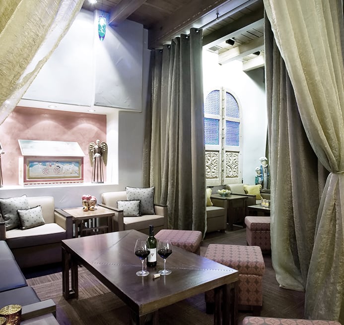 several casbah alcoves in the hotel lobby. Armchairs, couches, tables, and ottomans, along with lavish decorations