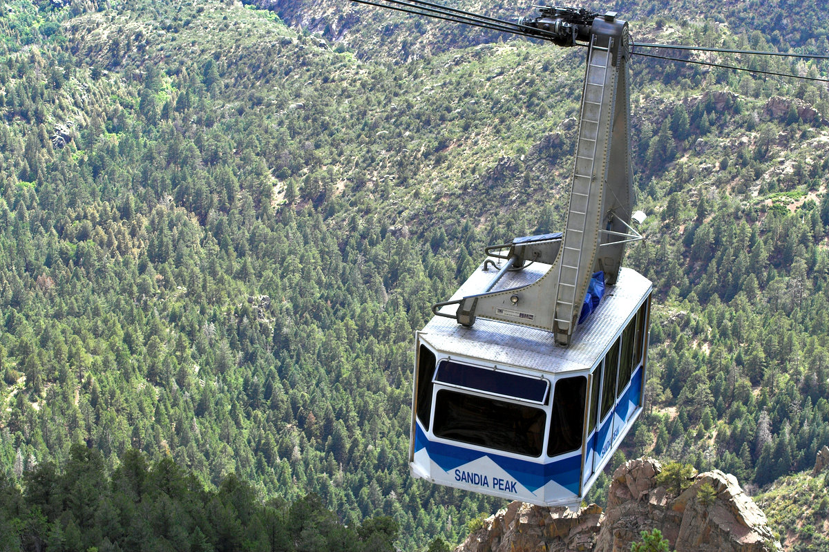 the sandia tram making its way up the mountains