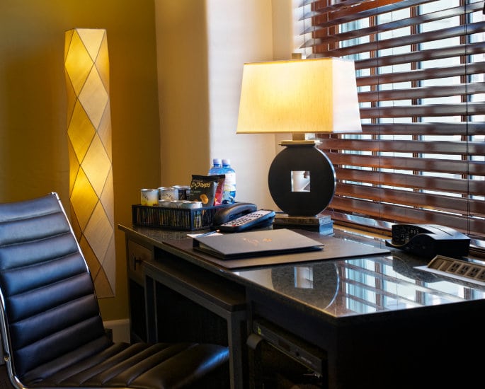 a desk in one of the hotel's guest rooms. It's stocked with snacks, drinks, and other amenities provided to guests.